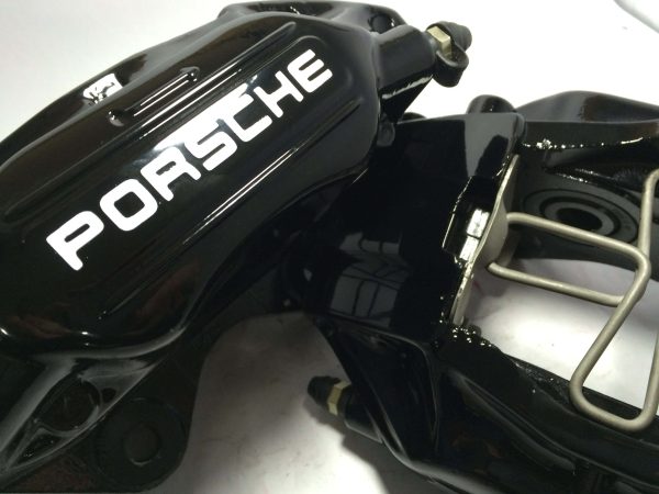 Black Porsche brake caliper with old Porsche decals in white
