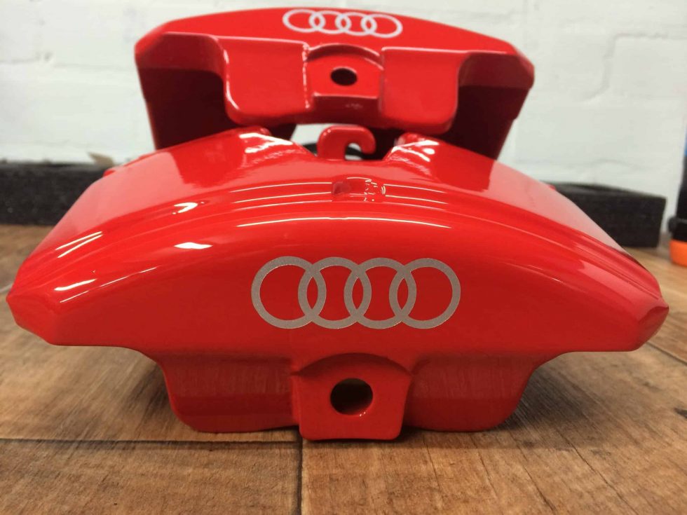 Audi brake caliper refurbished and painted red with Audi rings